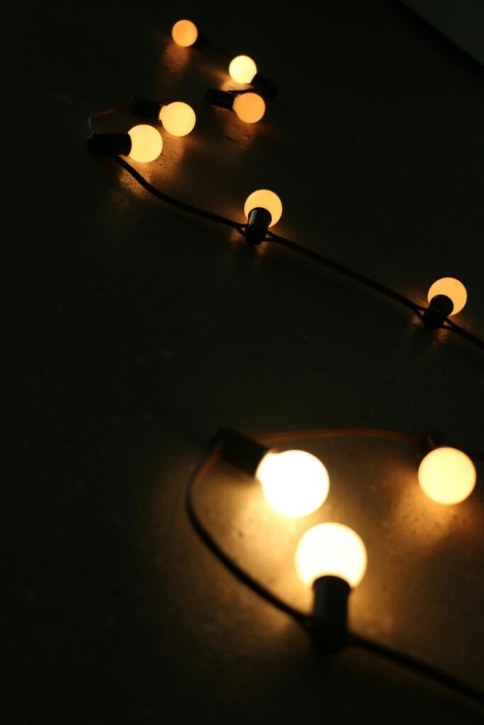 pexels-photo-238218-238218 Warm glowing string lights creating a soft ambiance on a dark surface.